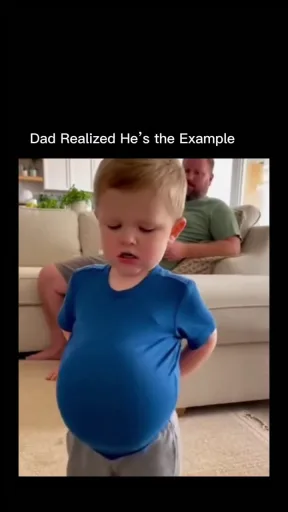 An AI-generated video of a toddler boy stuffing his shirt to imitate his father's large belly while his parents react.